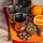 A vibrant collection of spices and citrus prepared for a refreshing drink.