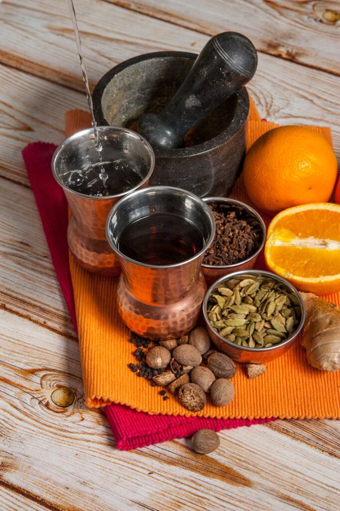A vibrant collection of spices and citrus prepared for a refreshing drink.
