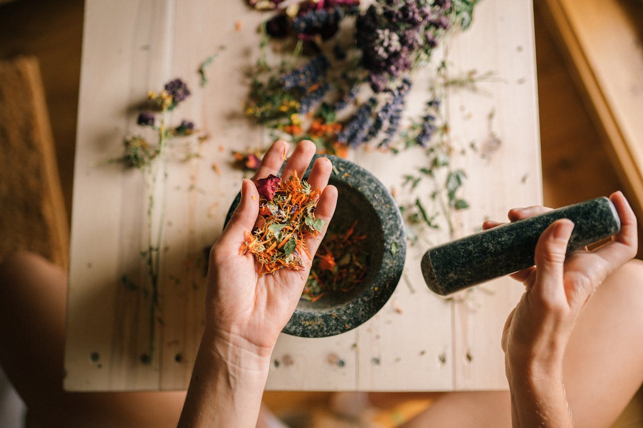 Home Hands grinding dried herbs with a mortar and pestle, perfect for holistic medicine and aromatherapy.